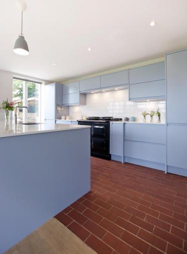 Staffs red rectangular quarry tiles laid over underfloor heating in a contemporary kitchen